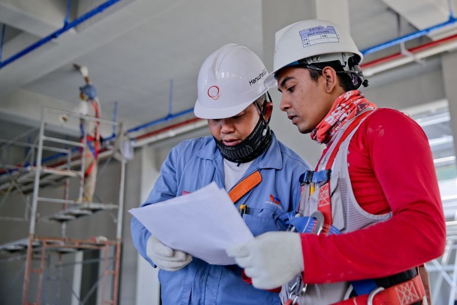 Construction crew in safety helmets on an active site